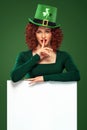 St Patrick Day. Young oktoberfest woman, wearing a dress and green hat with white banner for copy space Royalty Free Stock Photo