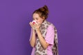 Half-length portrait of young sick girl isolated on purple, lilac color studio background. Concept of human emotions