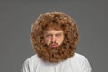 Half-length portrait of young very hairy man isolated over grey background. Royalty Free Stock Photo
