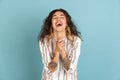 Half-length shot of Latino beautiful girl, fashion female model with tattoo on her hands on light blue studio