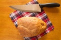 Half loaf of highbrow with a knife. Royalty Free Stock Photo