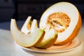 Half melon and melon slices on white plate close Royalty Free Stock Photo