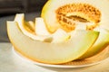 Half melon and melon slices on white plate close Royalty Free Stock Photo