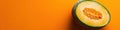 Half Melon on Orange Background Royalty Free Stock Photo