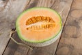 Half of melon on wood table. Royalty Free Stock Photo