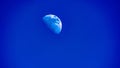 Half moon on blue daylight sky Royalty Free Stock Photo