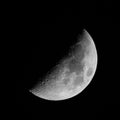 Half Moon with craters on black sky background