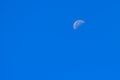 Half Moon During Day in Blue Sky. Bright moon orbiting earth in Royalty Free Stock Photo