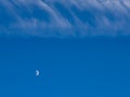 Half Moon in the Day Sky with Whispy Clouds Royalty Free Stock Photo