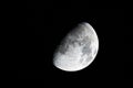 Half moon during the first quarter phase isolated against a black sky at night Royalty Free Stock Photo