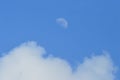 Half moon and the white clouds in the blue sky Royalty Free Stock Photo