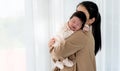 half Nigerian half Thai, 1-month-old baby newborn girl, sleeping with her mother being held Royalty Free Stock Photo