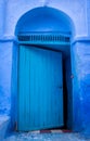 Half-open blue door in Chefchaouen, Medina, Morocco Royalty Free Stock Photo