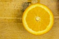 Half orange on a chopping board.