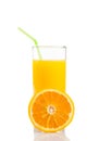 Half orange in front of glass of orange juice with straw on white background Royalty Free Stock Photo