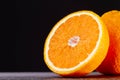 Half an orange. Two halves of fruit on a wooden table. Copyspace. Royalty Free Stock Photo