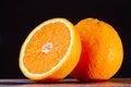 Half an orange. Two halves of fruit on a wooden table. Copyspace. Royalty Free Stock Photo