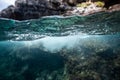 Half over half underwater shot on a beautiful bay in Palma de Mallorca, Coast line water line macro shot, underwater photography Royalty Free Stock Photo