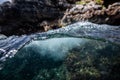 Half over half underwater shot on a beautiful bay in Palma de Mallorca, Coast line water line macro shot, underwater photography Royalty Free Stock Photo