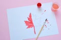 Half-painted maple leaf, paint and brush. Unfinished work. Quitter. Pass of difficulties. Autumn melancholy Royalty Free Stock Photo
