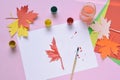 Half-painted maple leaf, paint and brush. Unfinished work. Quitter. Pass of difficulties. Autumn melancholy Royalty Free Stock Photo