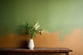 a half-painted wall transitioning from brown to green