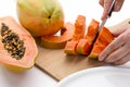 Half A Papaya Fruit Being Cut Into Slices