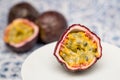 Half of a passion fruit with two other fruits in the background Royalty Free Stock Photo
