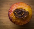 Half of peach with stone in shape of an eye Royalty Free Stock Photo