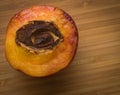 Half of peach with stone in shape of an eye Royalty Free Stock Photo