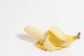 Half peeled banana isolated on a white background. Royalty Free Stock Photo