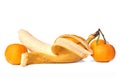 Half peeled banana with tangerines isolated on white background Royalty Free Stock Photo