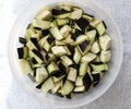 half peeled diced eggplant slices in bowl