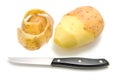 Half peeled potato with knife Royalty Free Stock Photo