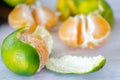 Half-peeled unripe tangerines,close up,