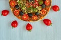 A half of pizza on the gray background with copy space. Vegetarian pizza with mushrooms, tomatoes, black olives and spices