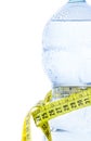 Half plastic bottle with water, drops and measuring tape, concept of nutrition and diet Royalty Free Stock Photo