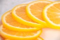 Half a plate with round slices of juicy orange on the table close up Royalty Free Stock Photo