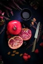 Half pomegranate and knife and cup