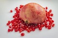 Half of pomegranate on top of red seeds on isoleted background Royalty Free Stock Photo