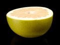 Half of pomelo, chinese grapefruit isolated on black