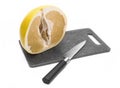 Half pomelo cut on the board. Knife. Royalty Free Stock Photo