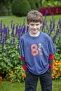 Half portrait of a smiling eight year old boy in a garden Royalty Free Stock Photo