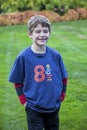 Half portrait of a smiling eight year old boy on a lawn Royalty Free Stock Photo