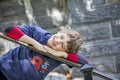 Half portrait of happy eight year old birthday boy wearing number 8 shirt leaning on stair rail