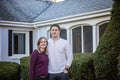 Half portrait of smiling young couple standing in front of first home Royalty Free Stock Photo