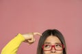 Half portrait of a young woman with eyeglasses scratching her head Royalty Free Stock Photo