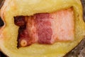 Potato half baked with bacon slice, top view close-up