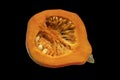 Half of pumpkin with pumpkin seeds. Isolated on black Royalty Free Stock Photo