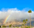 Half A Rainbow Coming Out Of Clouds In Desert With Palm Trees Royalty Free Stock Photo